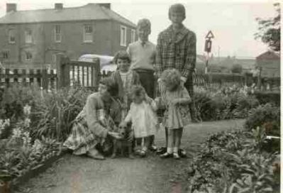 Nelson Sq
"This is another out side Grandfathers house\
Mary Willson (knelt) Elizabeth Wilson, Patricia Ward(me) Ann Wilson (Behind) Philip Ward Rosemary Ward,. and Whiskey the Dog"

