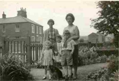 Outside 6 Nelson Square.
"Me (the one with Churly Hair) Rosemary Ward, Gregory Ward, \
Behind: Mary Wilson and Mam (Rose Ward nee Brocklebank)\
Also Whiskey the dog belonged to Alice Haile next door."

